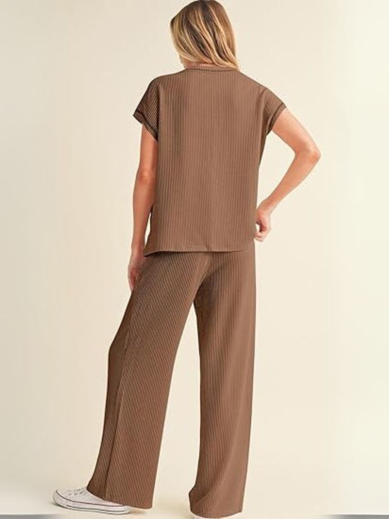 Woman wearing a brown ribbed outfit on a beige background