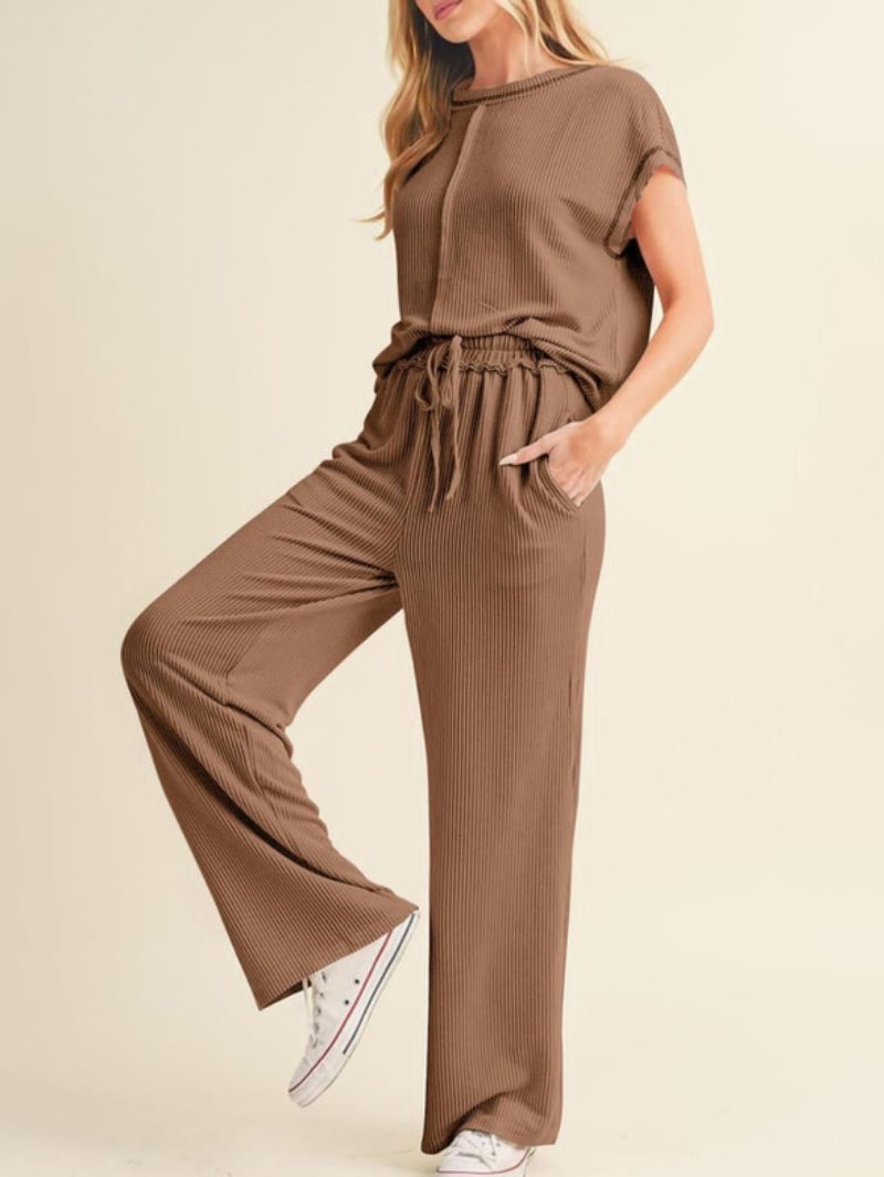 Brown ribbed knit outfit with wide-leg pants and a matching top on a beige background