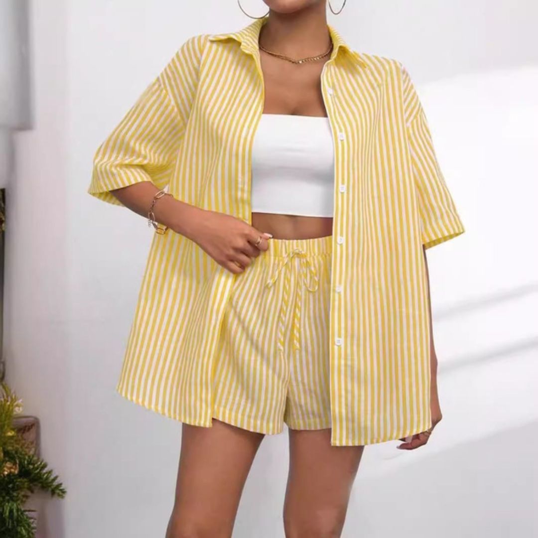 Woman wearing a yellow striped outfit with a white top against a neutral background